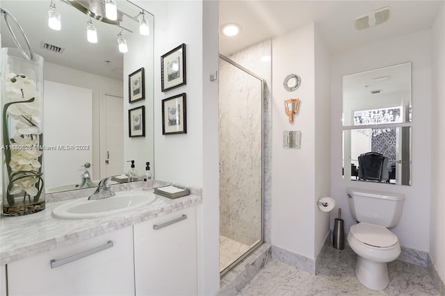 bathroom with walk in shower, vanity, and toilet