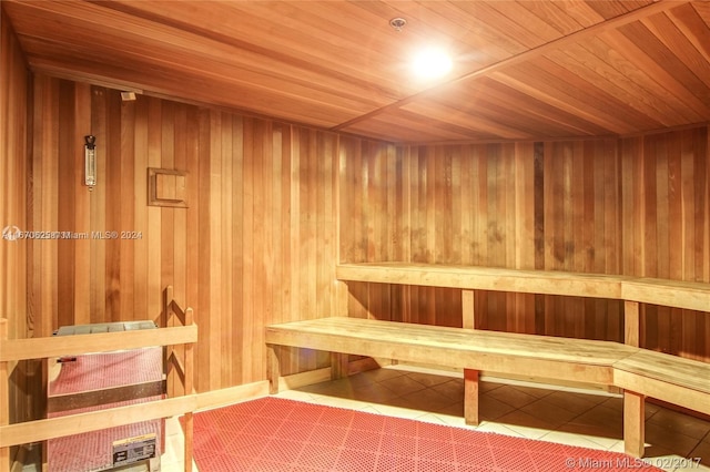 view of sauna with wooden walls and wooden ceiling