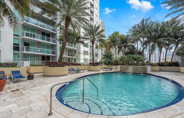 view of pool featuring pool water feature and a patio area