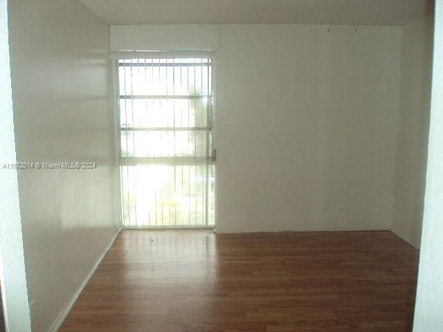 unfurnished room featuring hardwood / wood-style flooring