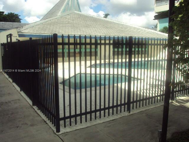 view of gate with a fenced in pool