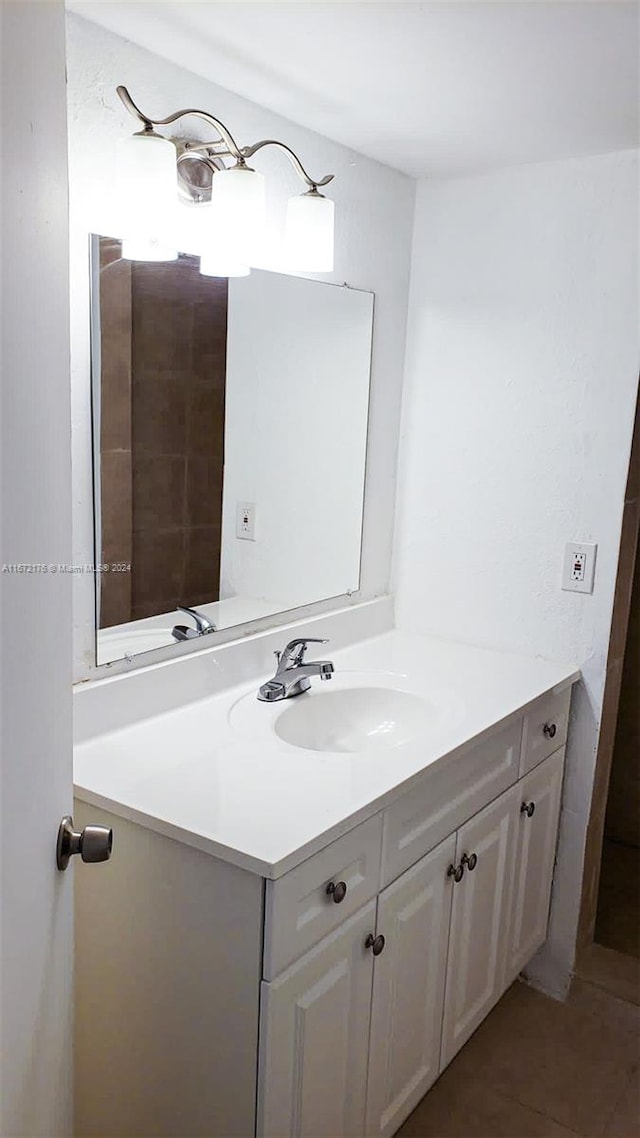 bathroom featuring tile patterned flooring and vanity