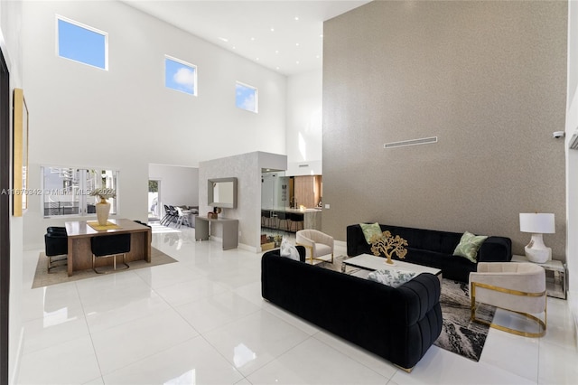 living room featuring a high ceiling and light tile patterned floors