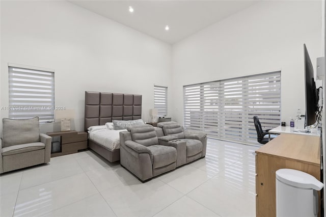 tiled bedroom featuring a high ceiling