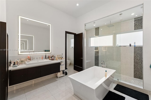 full bathroom with vanity, shower with separate bathtub, tile patterned flooring, and toilet