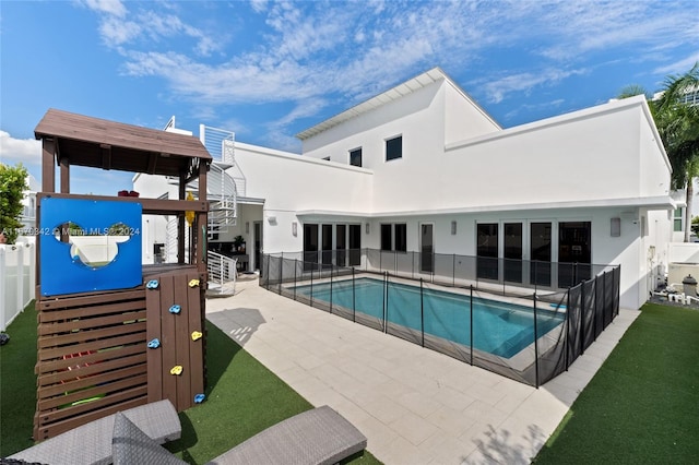 view of pool featuring a lawn and a patio