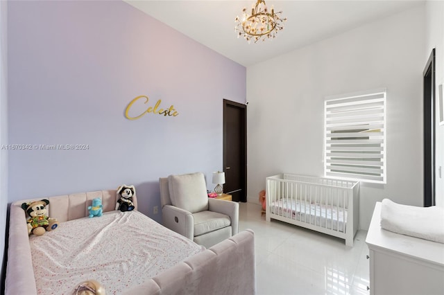 tiled bedroom with a chandelier and a crib