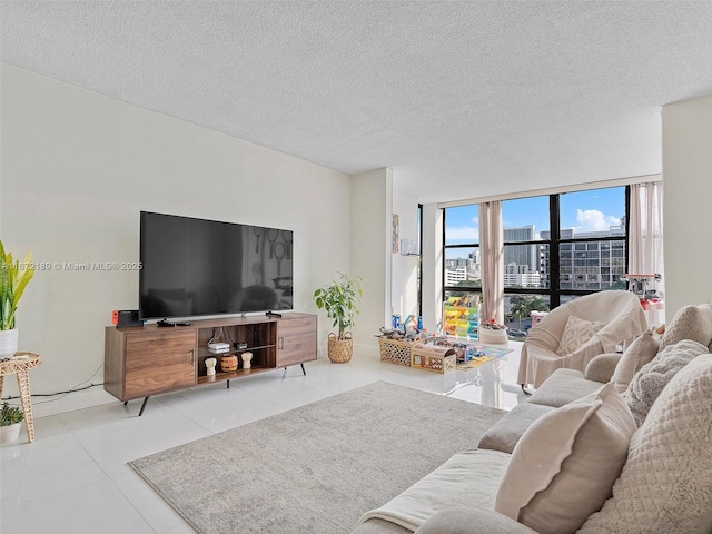 living room featuring expansive windows, light tile patterned floors, and a textured ceiling