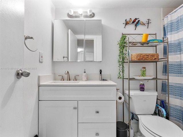 bathroom with vanity, toilet, and walk in shower