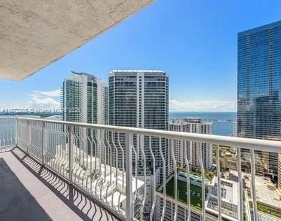 balcony featuring a water view and a view of city