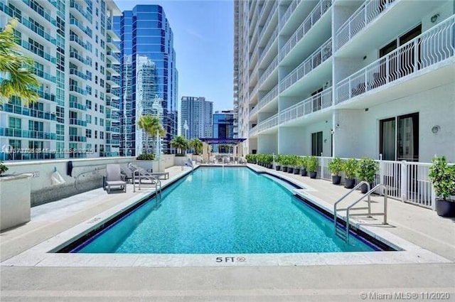 pool with a city view and a patio