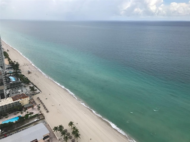 bird's eye view featuring a water view and a view of the beach