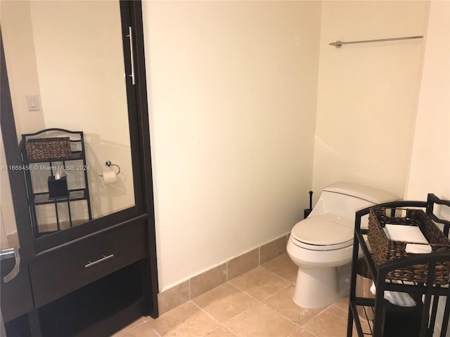 bathroom with tile patterned floors and toilet