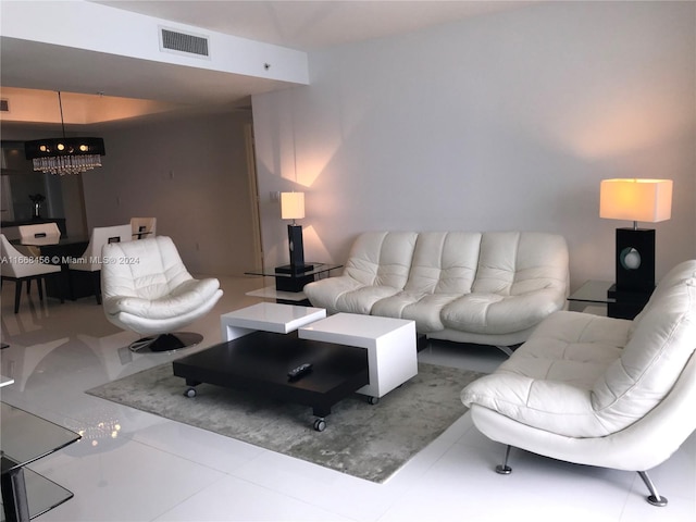 tiled living room featuring a chandelier