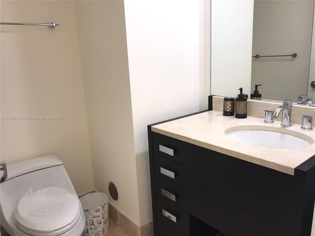 bathroom featuring vanity and toilet