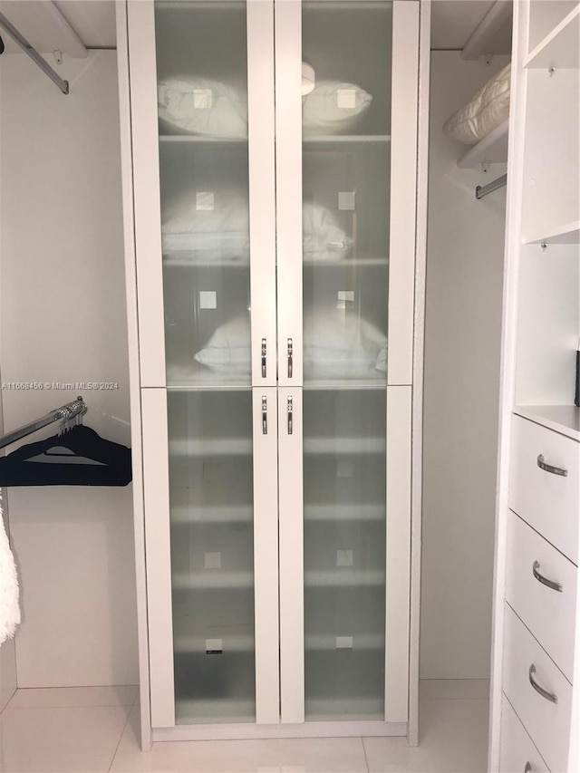 spacious closet featuring light tile patterned floors