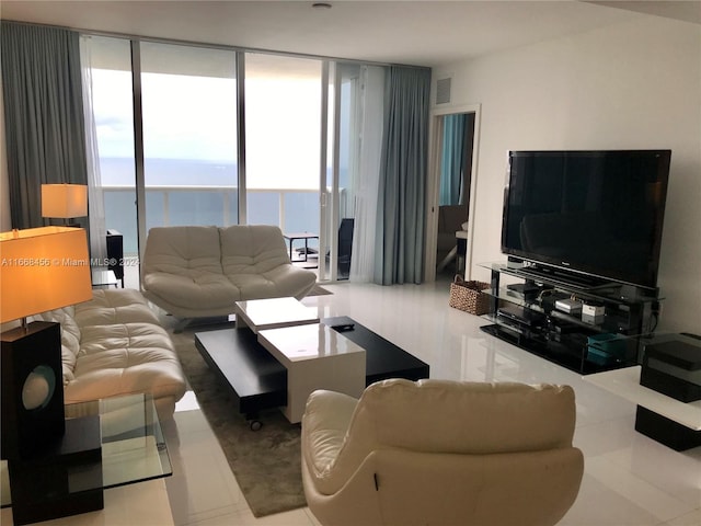 tiled living room with a wall of windows