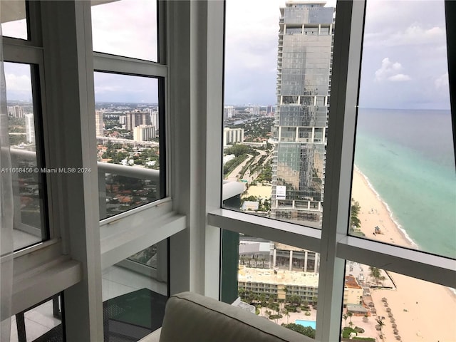 room details featuring a water view and a view of the beach