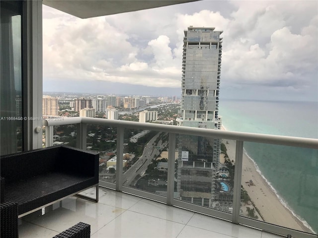 balcony with a water view and a beach view