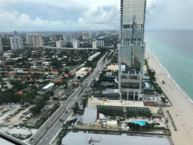 aerial view with a water view and a view of the beach