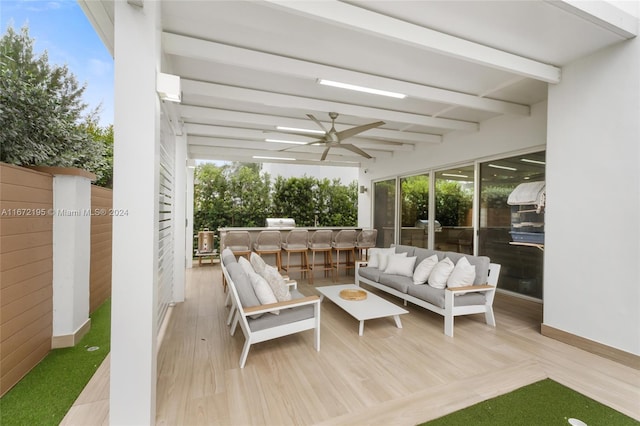 view of patio featuring a deck, an outdoor living space, and ceiling fan