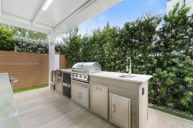 view of patio with exterior kitchen, grilling area, and sink