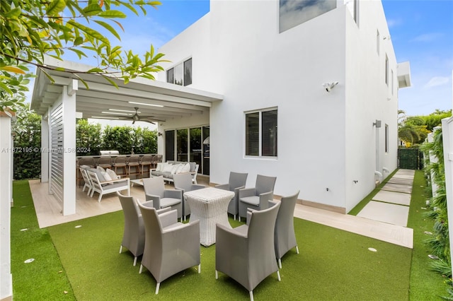 view of patio featuring ceiling fan and an outdoor living space