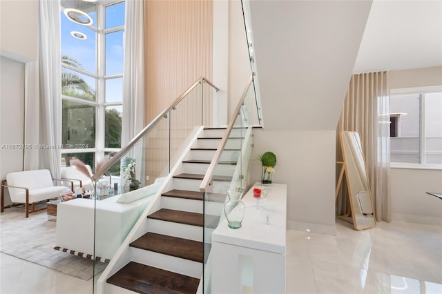 stairway featuring tile patterned flooring