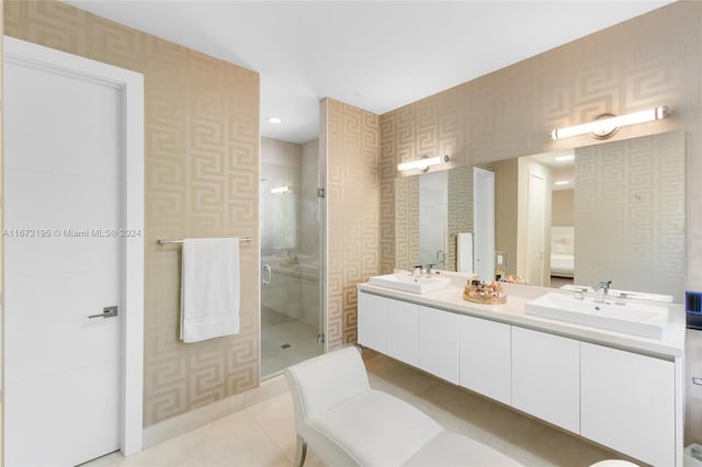 bathroom featuring tile patterned flooring, a shower with door, and vanity