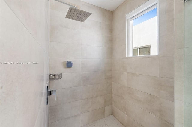 bathroom with a tile shower