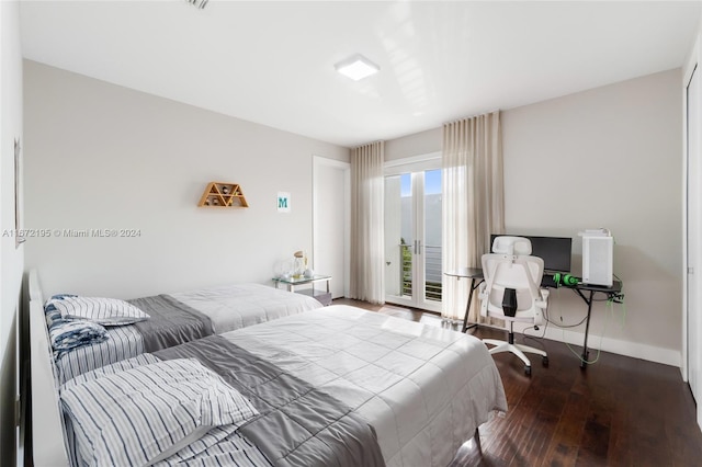 bedroom featuring wood-type flooring and access to outside