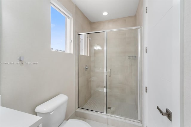 bathroom with walk in shower and toilet