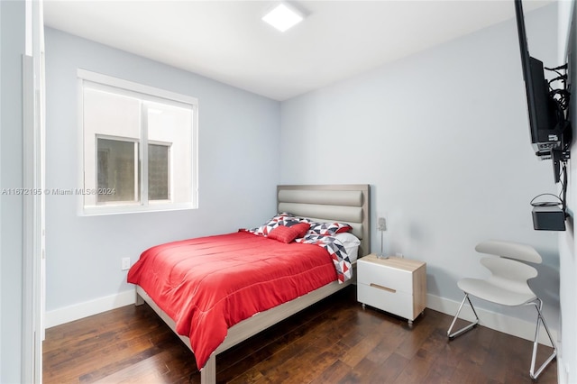 bedroom featuring dark hardwood / wood-style flooring