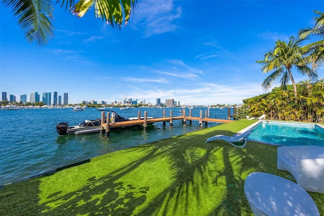 view of dock with a water view and a yard