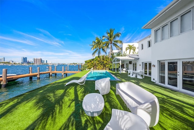 view of yard featuring a boat dock and a water view