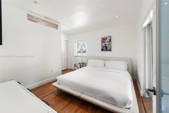 bedroom with wood-type flooring and a closet