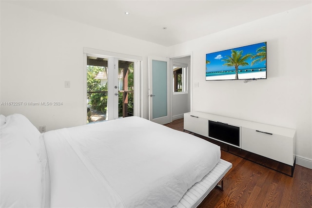 bedroom featuring access to exterior, dark wood-type flooring, and french doors