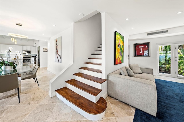 stairway featuring french doors