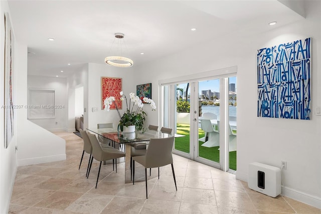 dining area with french doors and a water view