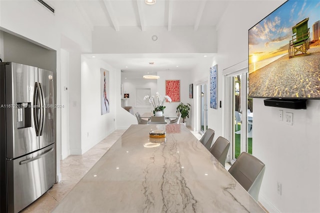 dining room featuring beamed ceiling