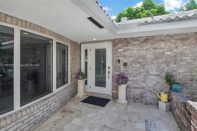 entrance to property featuring a patio