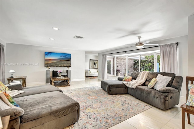 living room featuring ceiling fan and light tile patterned floors