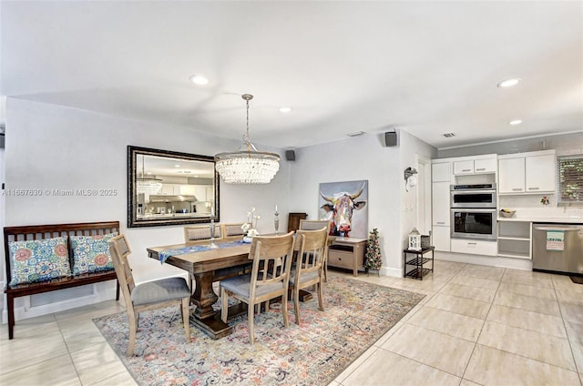 tiled dining area with a chandelier