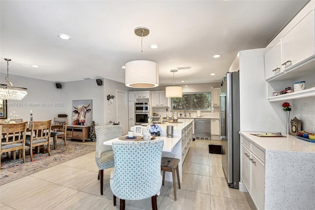 dining space with sink and light tile patterned floors