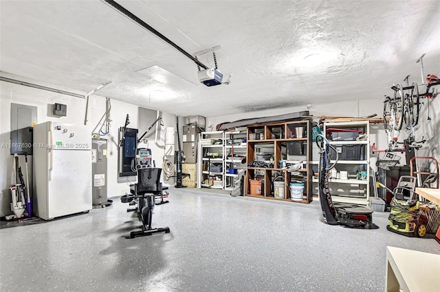 garage with a garage door opener, white refrigerator, and water heater