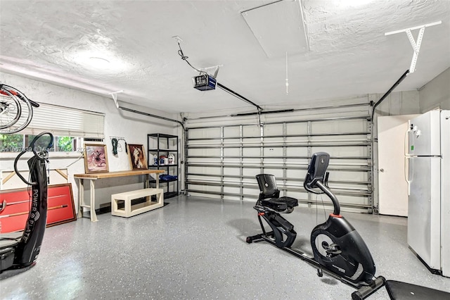 garage with white refrigerator and a garage door opener