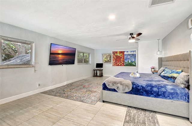 tiled bedroom featuring ceiling fan