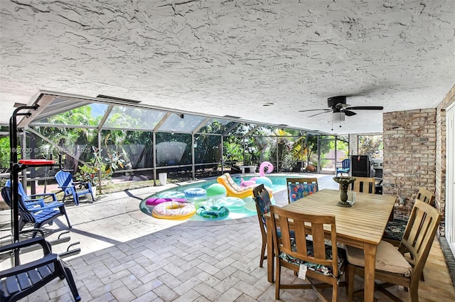 view of patio with ceiling fan and a lanai