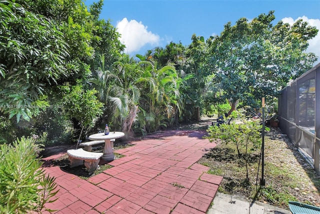 view of patio featuring a lanai