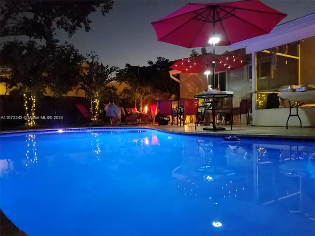 view of pool at night